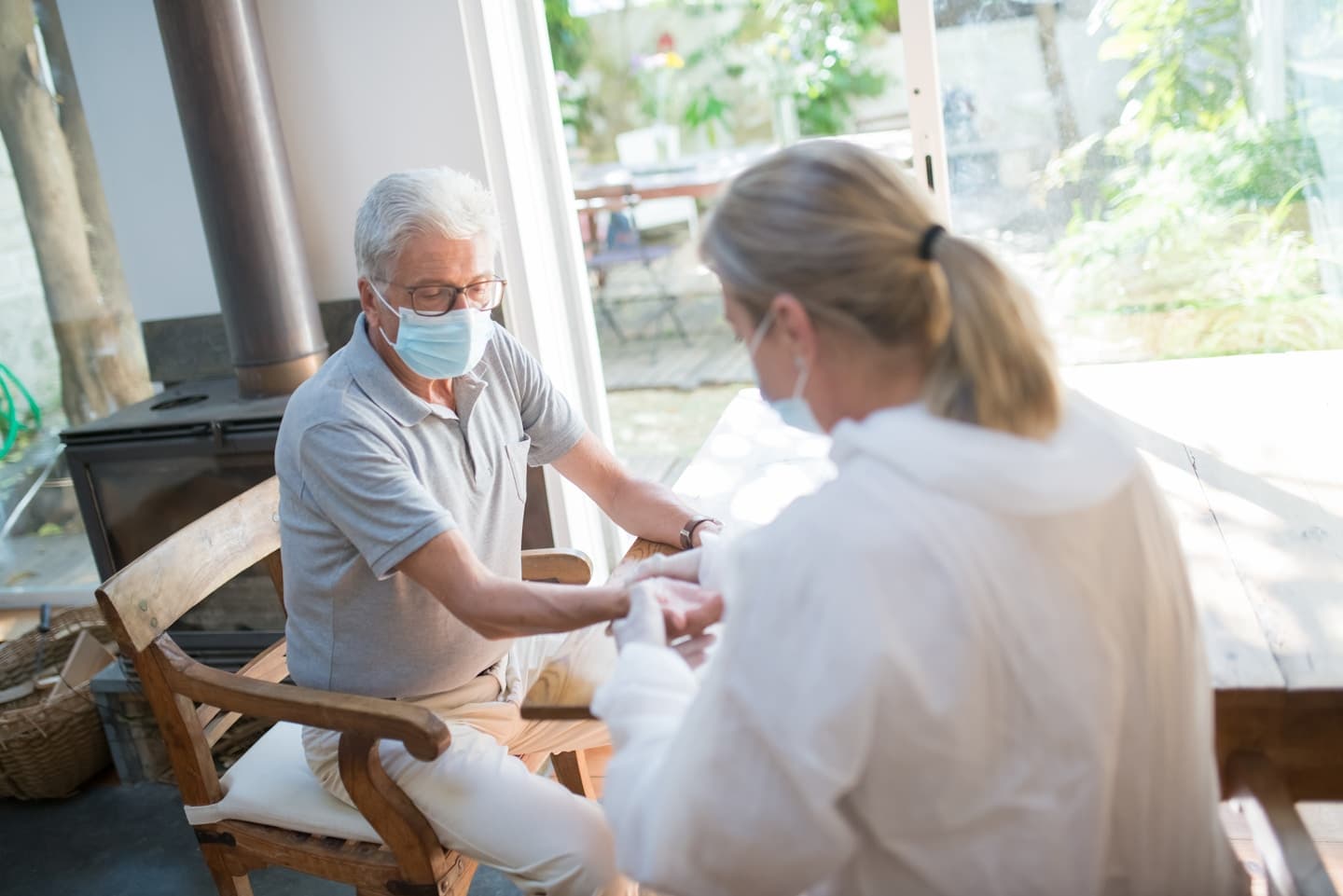 Doctor examining elderly patient at home during a hospital-at-home visit
